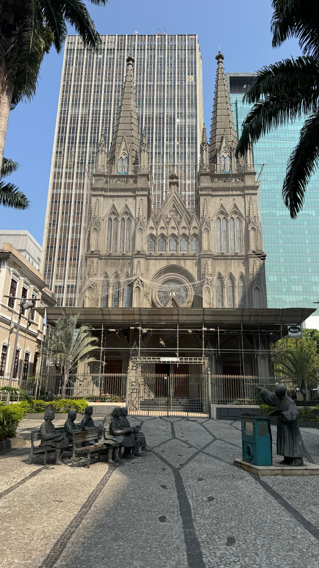 Gothic façade of the Presbyterian Cathedral framed by palms and modern towers