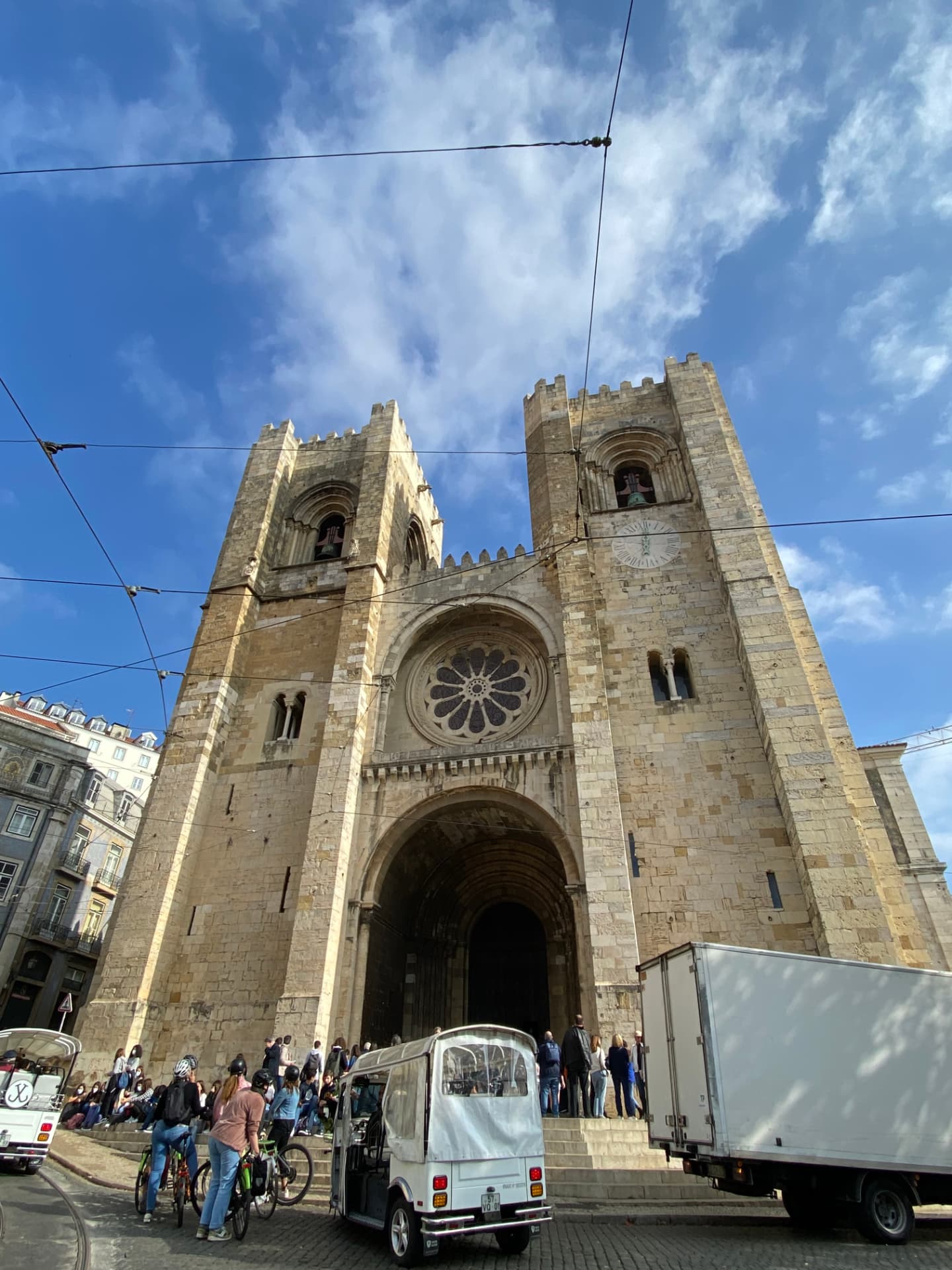 The stone façade of Lisbon Cathedral against a blue sky