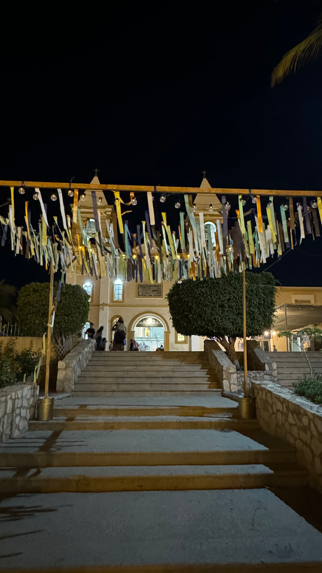 Mission church in San José del Cabo illuminated at night behind a ribbon canopy