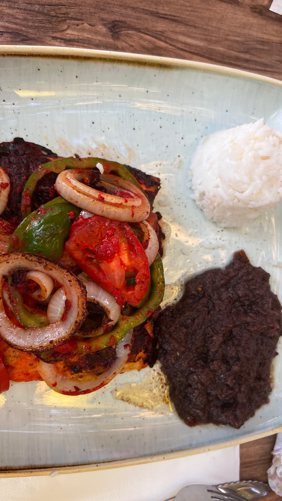 Grilled fish with peppers, onions, beans, and rice