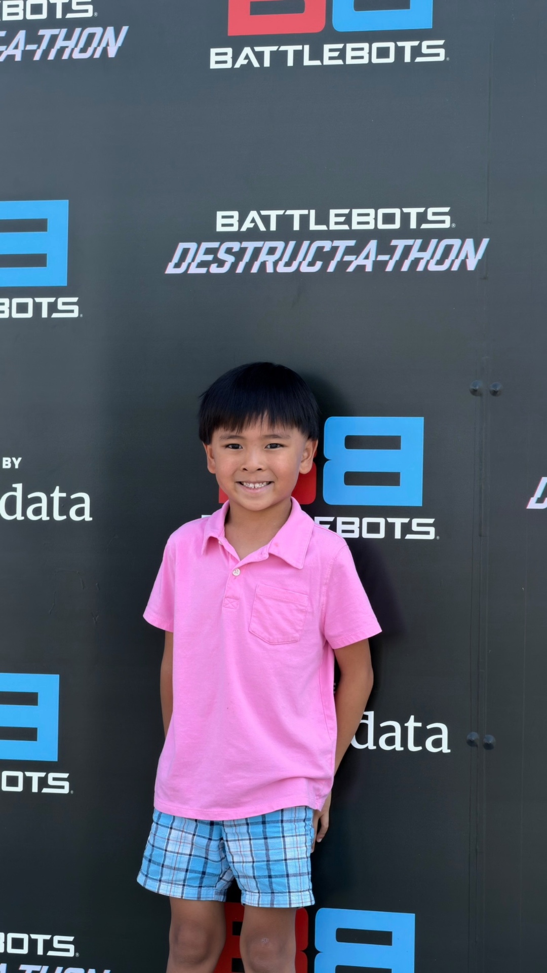 Kayden smiling in front of the BattleBots backdrop