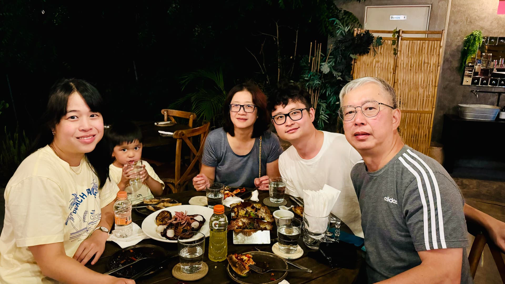 Five family members gathered around a restaurant table in Cabo