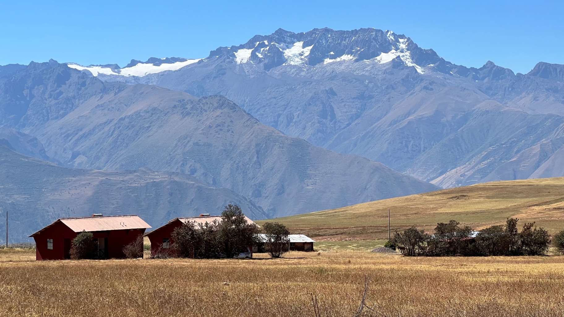 Sacred Valley farmland with a snow-capped Andean ridge beyond