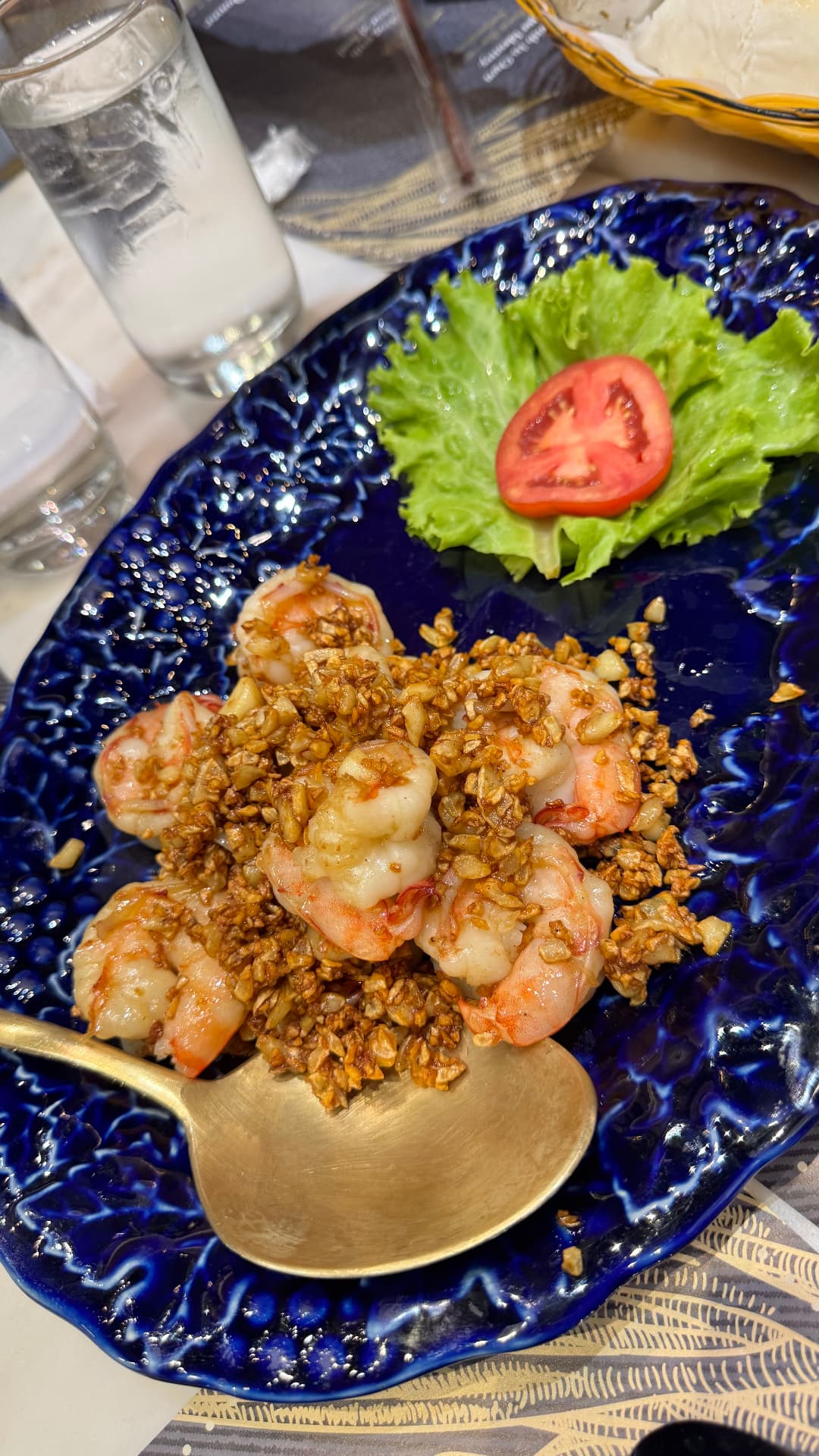 Garlic prawns on a deep blue serving plate