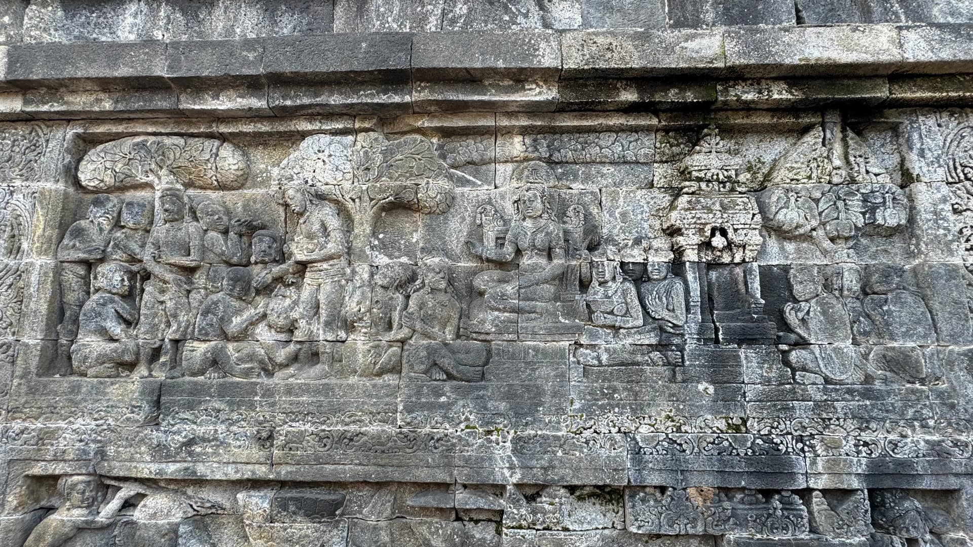 Stone reliefs depicting figures beneath trees