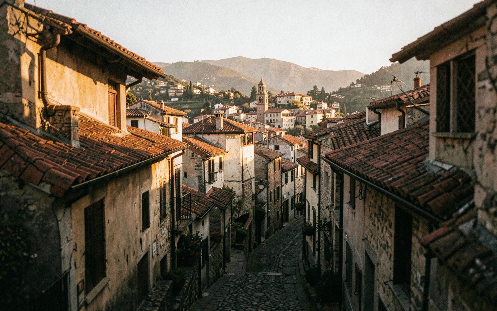 A narrow cobbled lane in an old hill town at golden hour